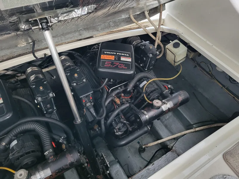 Slide: The Image of Engine compartment of a 1997 Larson 290 CABRIO boat, featuring Volvo Penta components. - 43