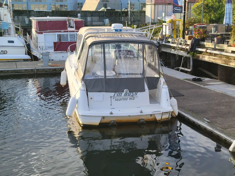 Slide: The Image of 1997 Larson 290 Cabrio boat docked in marina, rear view. - 7