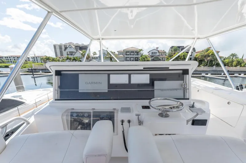 Slide: The Image of Bertram 630 yacht helm, 2004 model, featuring Garmin navigation, docked in a marina. - 11