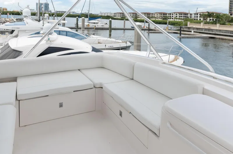 Slide: The Image of Luxurious seating area on a 2004 Bertram 630 yacht docked at a marina. - 14