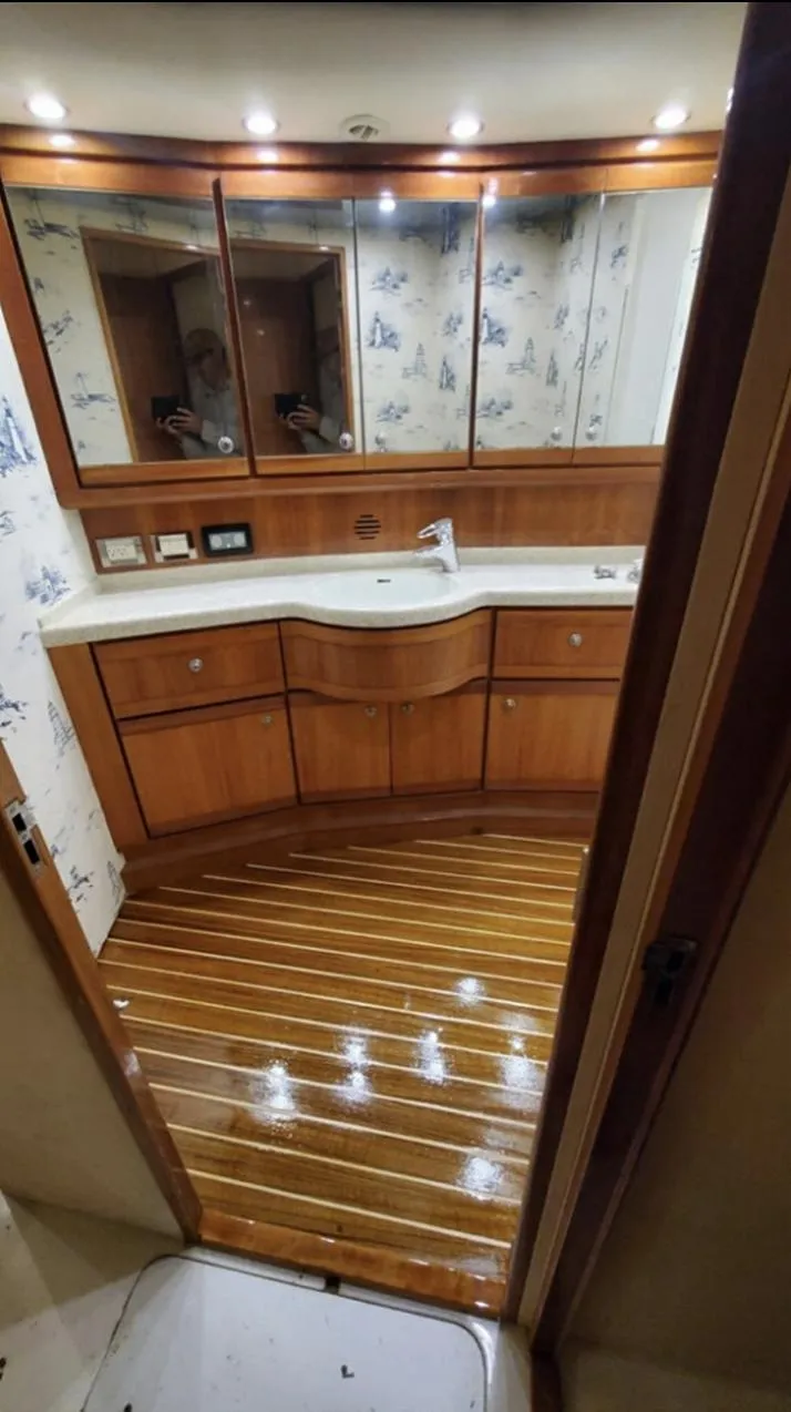 Slide: The Image of Luxurious bathroom in 2004 Bertram 630 yacht with wooden flooring and elegant cabinetry. - 17