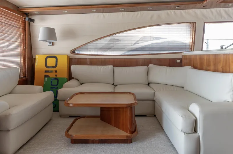 Slide: The Image of Luxurious interior of a 2004 Bertram 630 yacht with plush seating and wooden accents. - 3