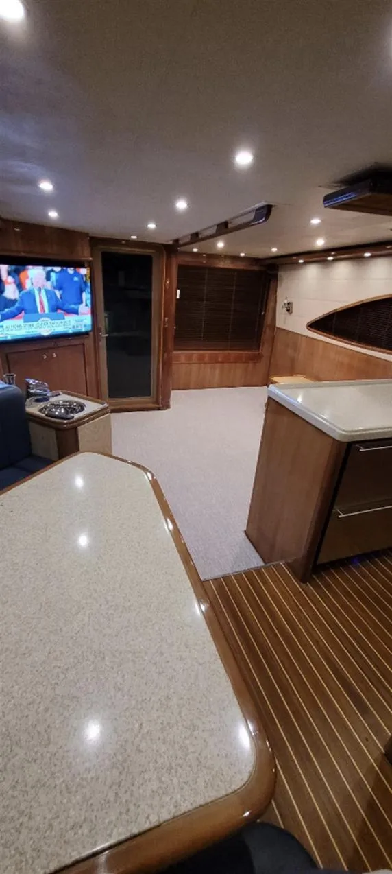 Slide: The Image of Luxurious interior of 2004 Bertram 630 yacht with modern amenities and wood finishes. - 4