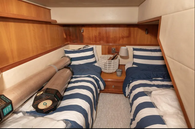 Slide: The Image of Cozy twin cabin with striped bedding in 2004 Bertram 630 yacht. - 8