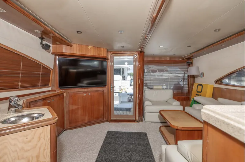 Slide: The Image of Luxurious interior of 2004 Bertram 630 yacht with modern furnishings and entertainment system. - 9