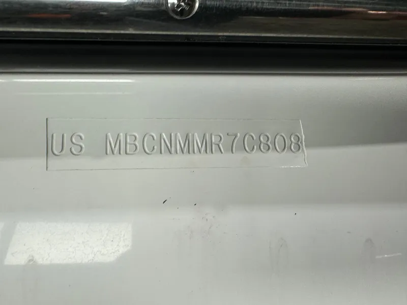 Slide: The Image of 2008 MasterCraft X-15 boat hull identification number (HIN) embossed on white surface. - 13
