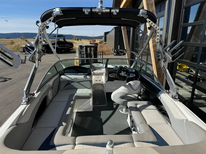Slide: The Image of 2008 MasterCraft X-15 boat interior with seating and control panel, docked outdoors. - 9