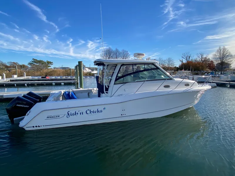 Slide: The Image of 2020 Boston Whaler 345 Conquest boat docked in marina under clear blue sky. - 0