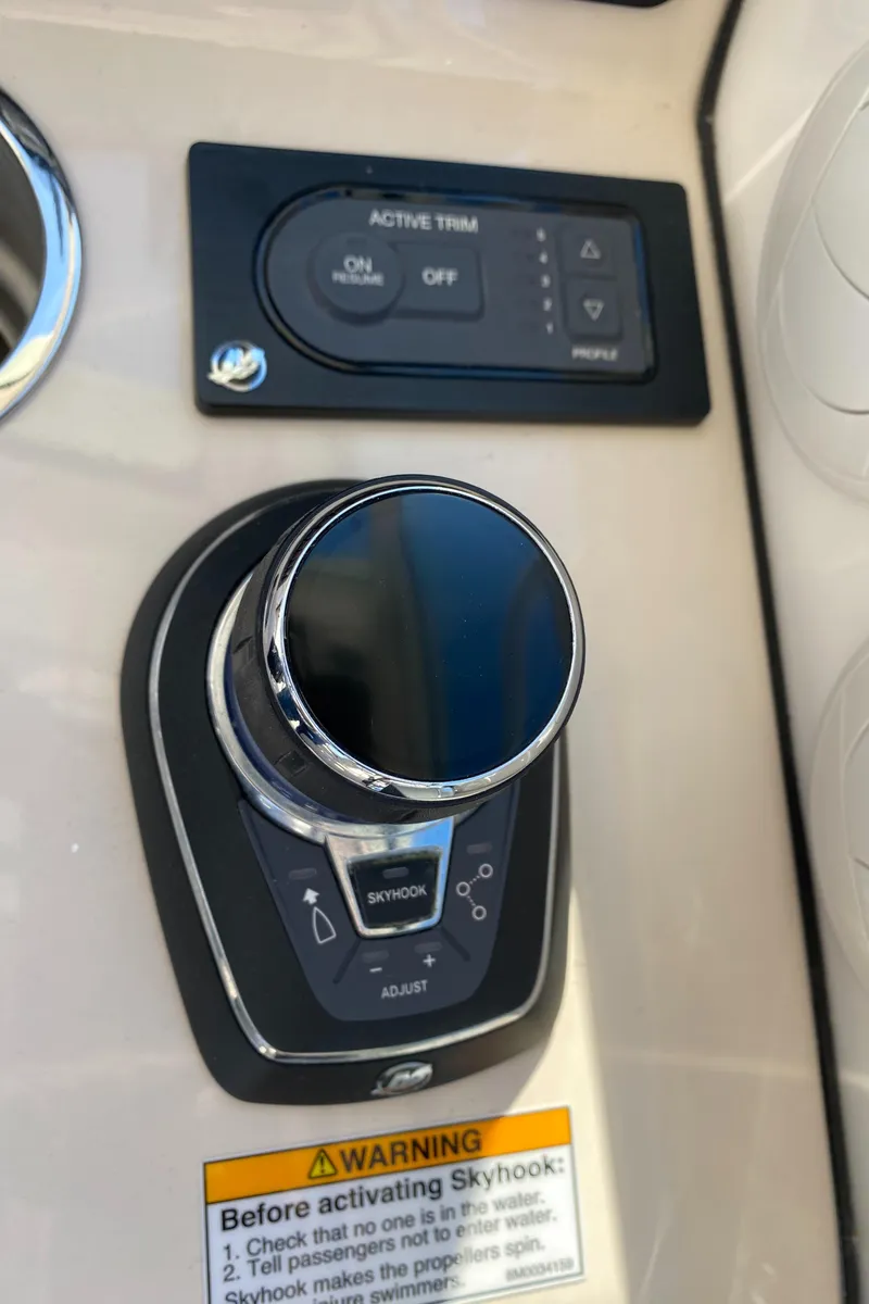 Slide: The Image of Boston Whaler 345 Conquest 2020 boat control panel with active trim and Skyhook warning. - 15