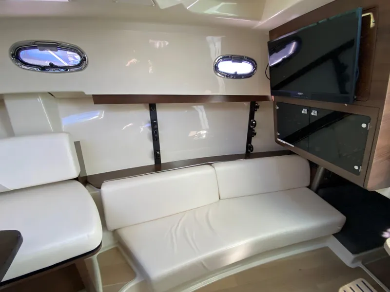 Slide: The Image of Interior of 2020 Boston Whaler 345 Conquest with white seating and mounted TV. - 22