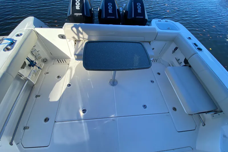 Slide: The Image of Boston Whaler 345 Conquest 2020 boat deck with table and seating, overlooking water. - 5