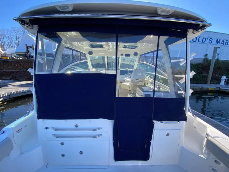 Slide: The Image of 2020 Boston Whaler 345 Conquest boat interior with blue canvas cover. - 6