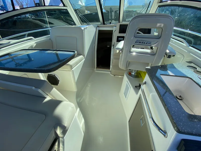 Slide: The Image of Interior of 2020 Boston Whaler 345 Conquest boat with seating and helm. - 8