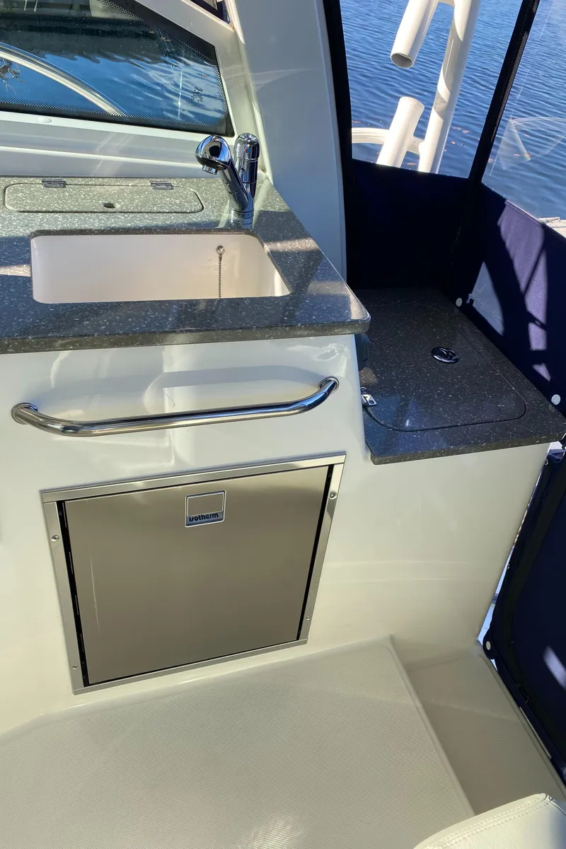 Slide: The Image of 2020 Boston Whaler 345 Conquest boat interior with sink and storage. - 9