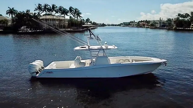 Slide: The Image of 2020 Invincible 39 Open Fisherman boat on a calm river with palm trees. - 11