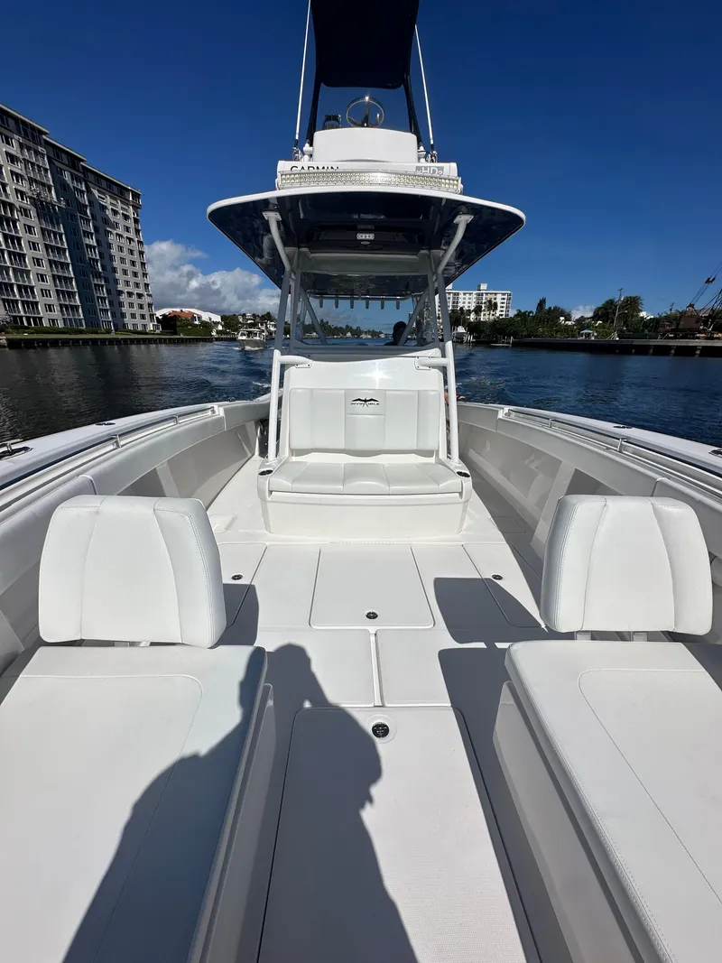 Slide: The Image of 2020 Invincible 39 Open Fisherman boat on calm water, clear sky background. - 15