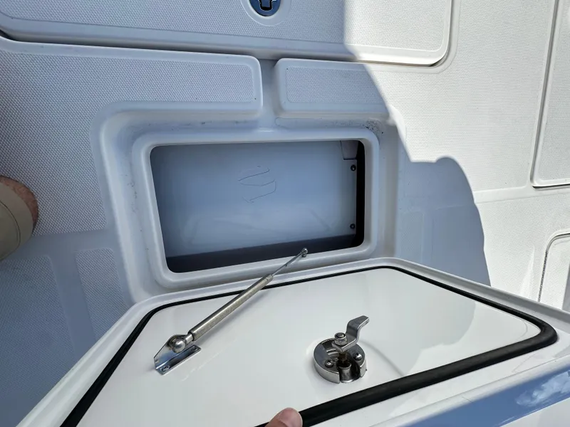Slide: The Image of 2020 Invincible 39 Open Fisherman storage compartment with open hatch and latch. - 17