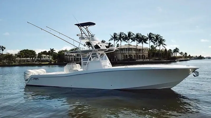 Slide: The Image of 2020 Invincible 39 Open Fisherman boat on calm water, palm trees in background. - 5