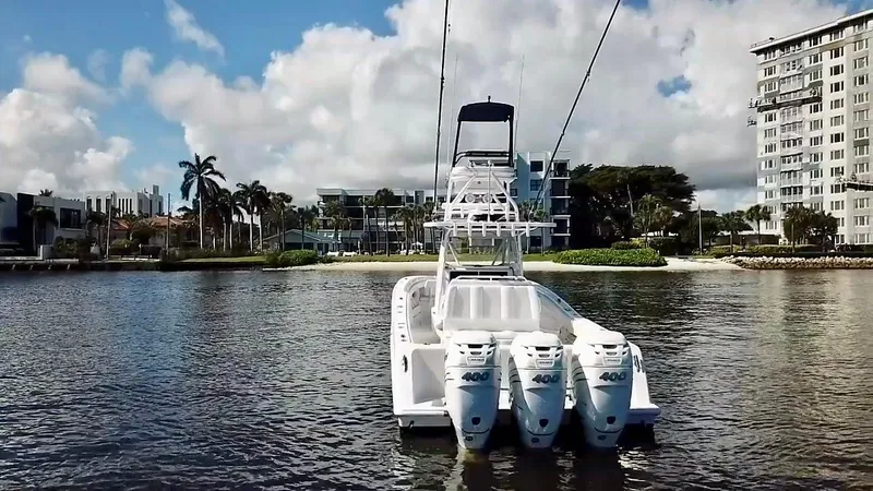 Slide: The Image of 2020 Invincible 39 Open Fisherman boat with triple engines on a calm waterway. - 8