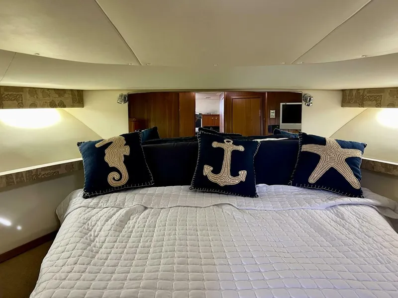 Slide: The Image of Luxurious 1997 Tiara Yachts 41 cabin with nautical-themed pillows. - 12
