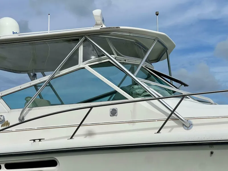 Slide: The Image of 1997 Tiara Yachts 41 boat with sleek design and sturdy structure against a blue sky. - 2