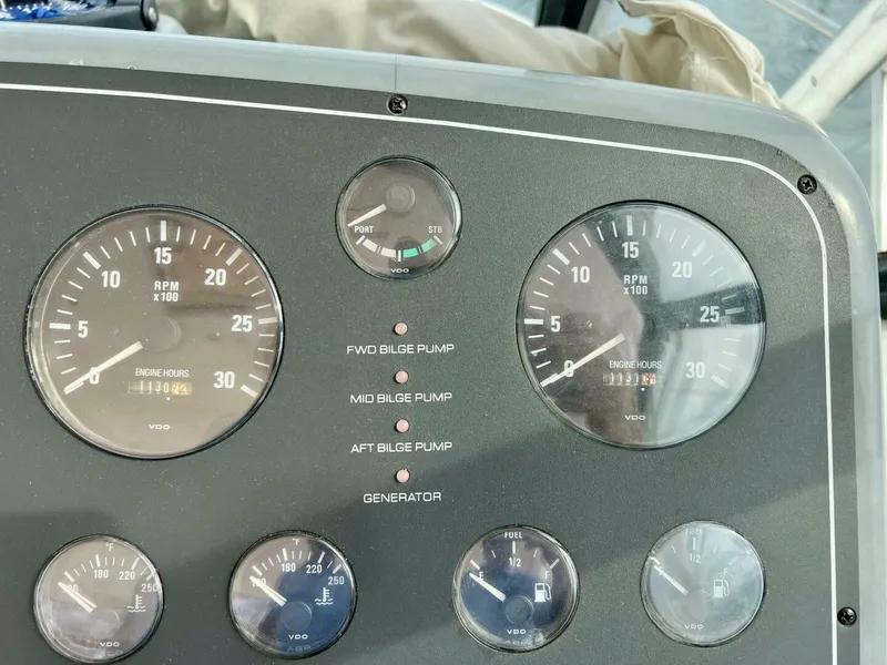 Slide: The Image of Dashboard of a 1997 Tiara Yachts 41 with gauges and bilge pump indicators. - 22