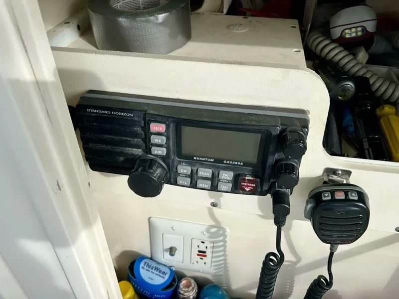 Slide: The Image of Marine radio equipment on a 1997 Tiara Yachts 41, with various boating supplies nearby. - 23