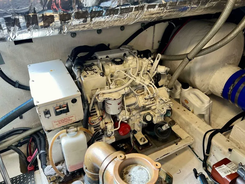Slide: The Image of Engine room of a 1997 Tiara Yachts 41, showcasing mechanical components and wiring. - 25