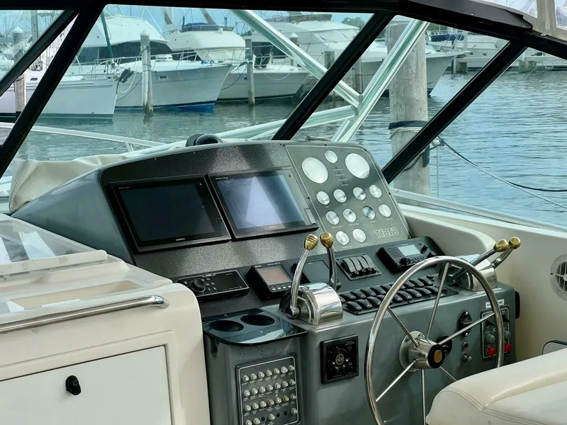 Slide: The Image of Tiara Yachts 41, 1997 model, helm with controls and navigation screens, docked at marina. - 5