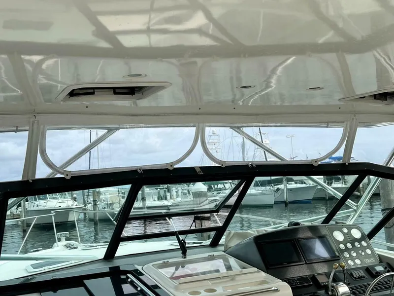 Slide: The Image of Interior view of 1997 Tiara Yachts 41 helm with marina background. - 6