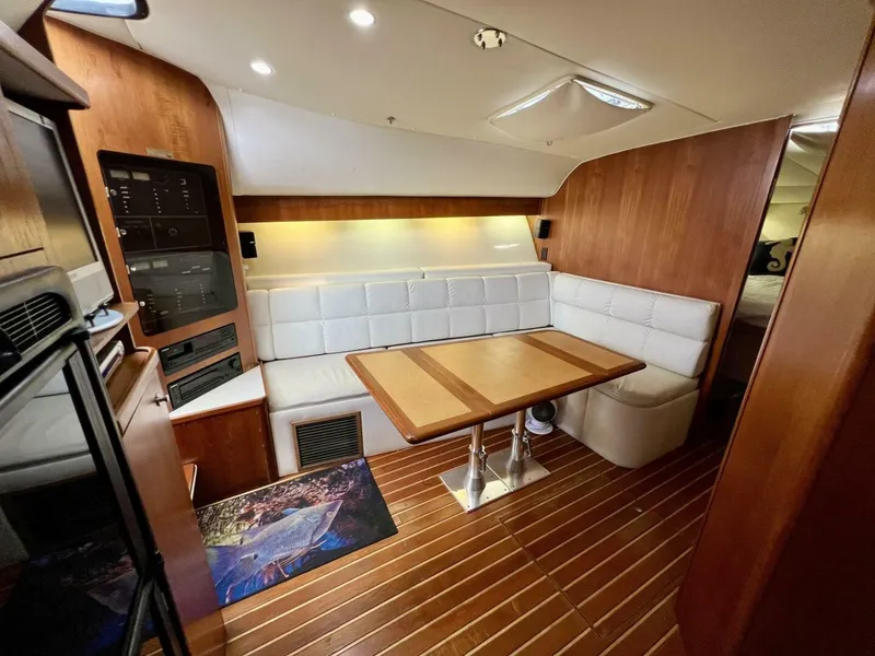 Slide: The Image of Interior of 1997 Tiara Yachts 41 with wood paneling and white seating. - 7