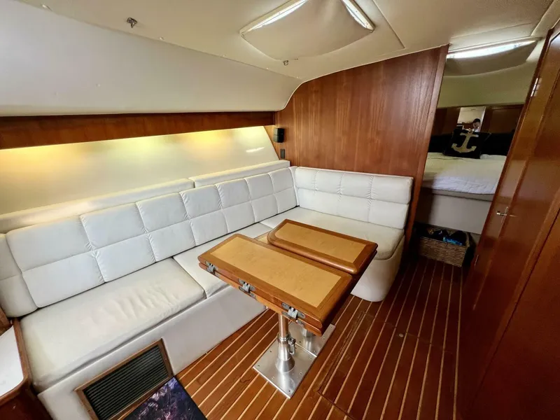 Slide: The Image of Luxurious interior of 1997 Tiara Yachts 41 with white seating and wooden accents. - 8