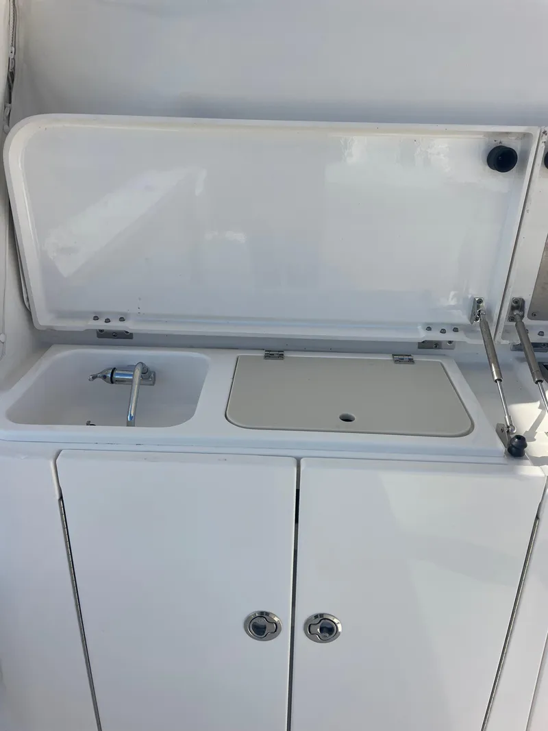 Slide: The Image of 2020 Pursuit 385 Offshore boat sink and storage area. - 11