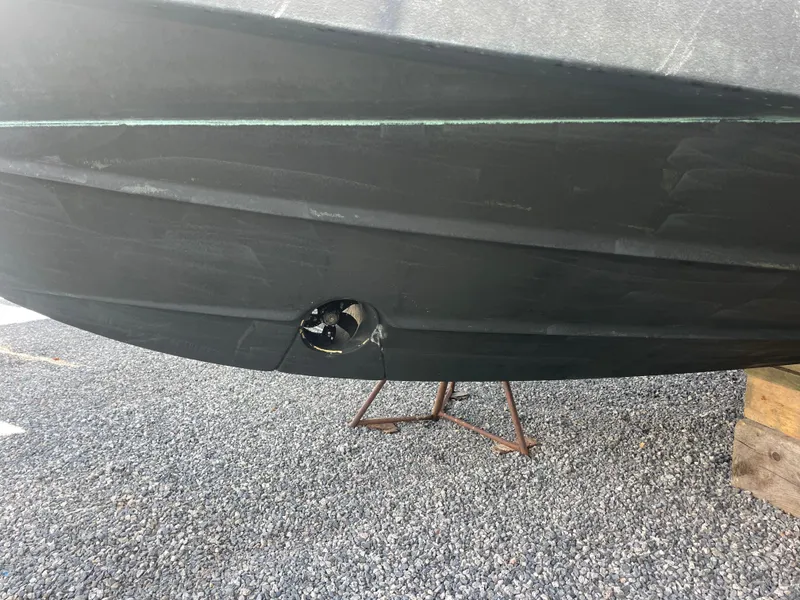 Slide: The Image of 2020 Pursuit 385 Offshore boat hull on gravel with support stand. - 12