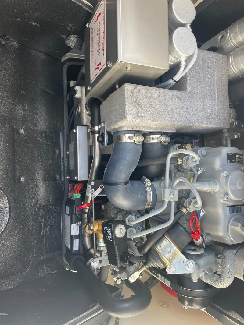 Slide: The Image of Engine compartment of 2020 Pursuit 385 Offshore boat, showcasing mechanical components. - 15