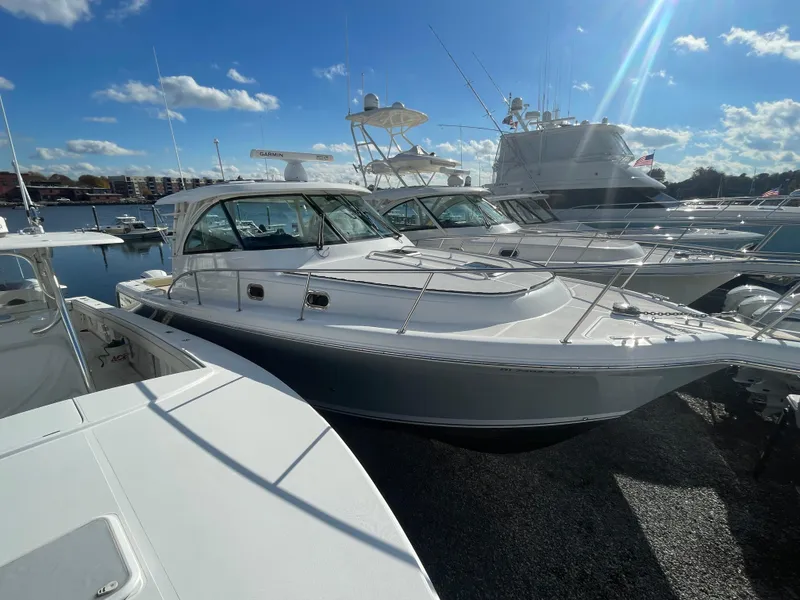 Slide: The Image of 2020 Pursuit 385 Offshore boat docked under a clear blue sky. - 2