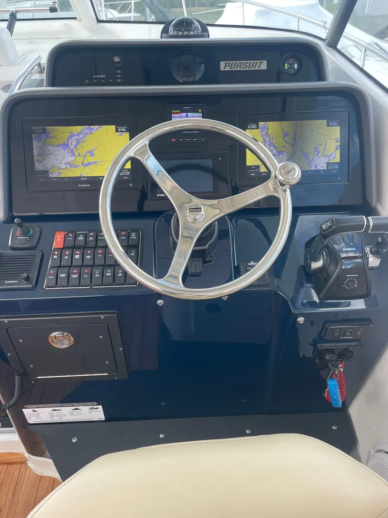 Slide: The Image of 2020 Pursuit 385 Offshore helm with dual navigation screens and steering wheel. - 22
