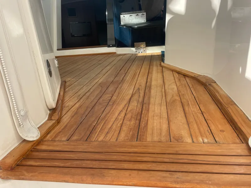 Slide: The Image of Teak deck of 2020 Pursuit 385 Offshore boat, showcasing elegant wood finish. - 24