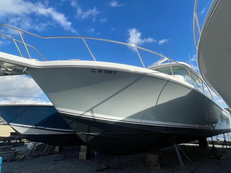 Slide: The Image of 2020 Pursuit 385 Offshore boat on display under a clear blue sky. - 3