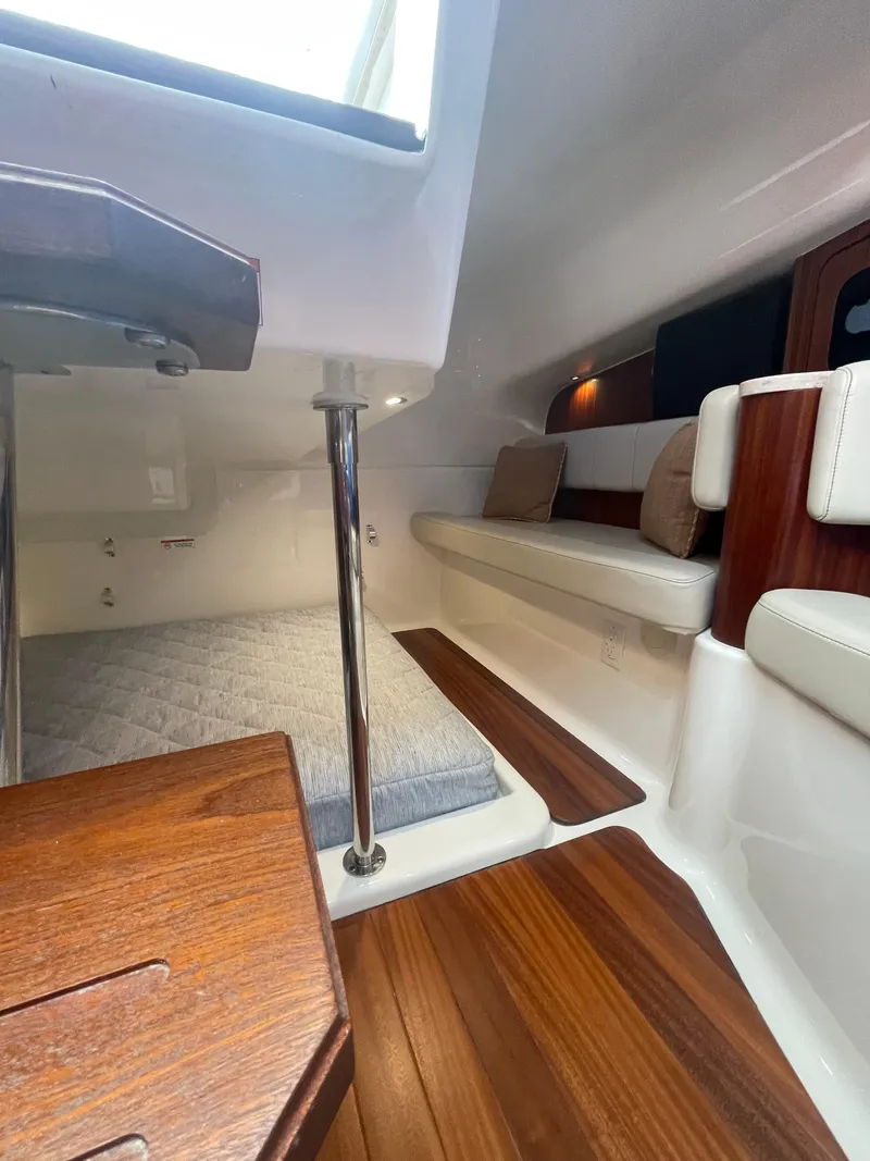 Slide: The Image of Interior of 2020 Pursuit 385 Offshore boat with wood flooring and seating area. - 32