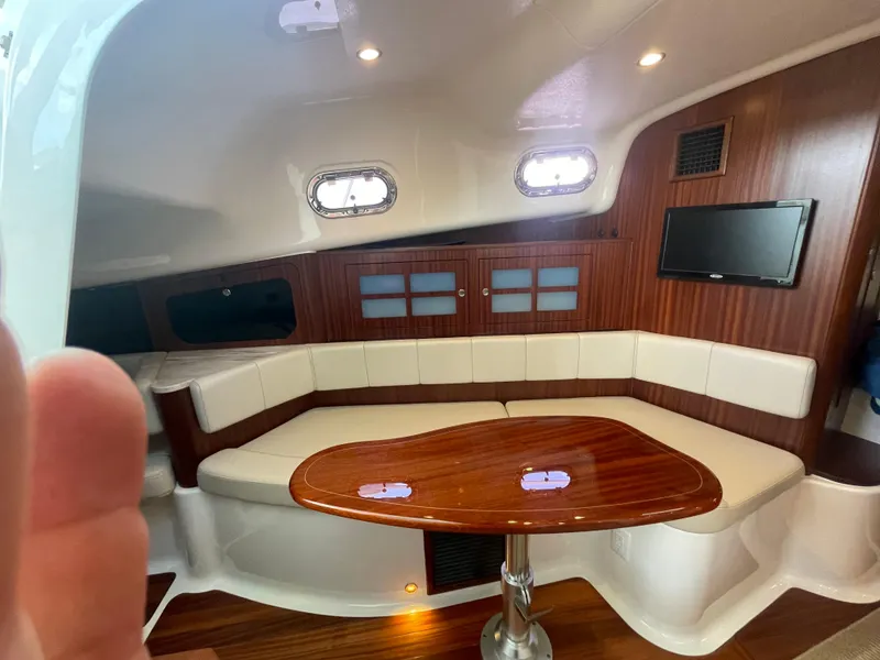 Slide: The Image of Luxurious interior of 2020 Pursuit 385 Offshore yacht with elegant seating and wooden table. - 33