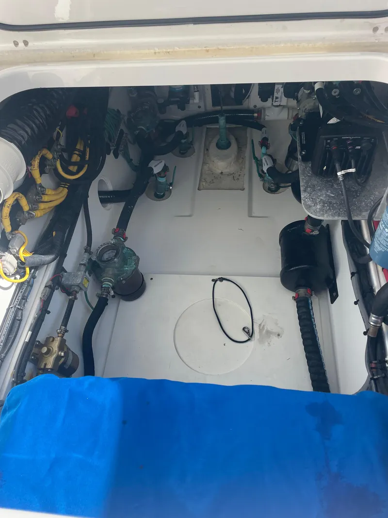 Slide: The Image of Engine compartment of a 2020 Pursuit 385 Offshore boat, showcasing mechanical components. - 38