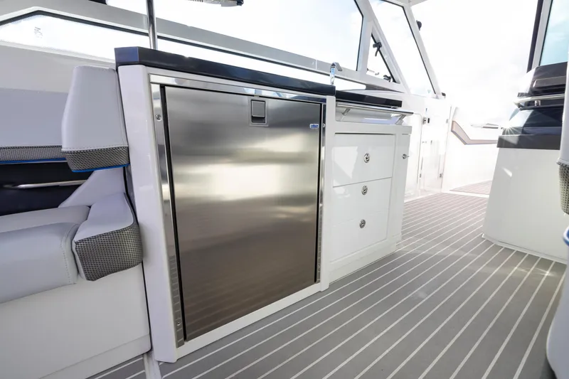 Slide: The Image of 2019 Formula 430 Super Sport Crossover interior with sleek stainless steel fridge and modern cabinetry. - 19