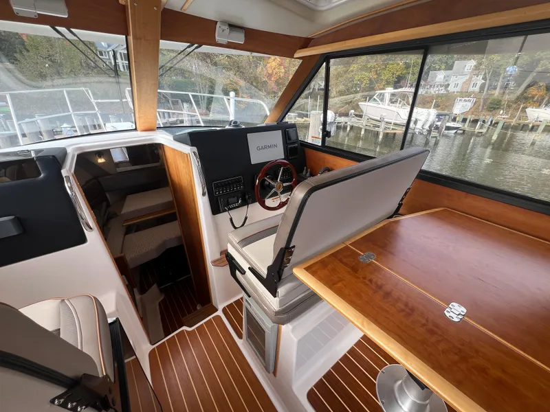 Slide: The Image of Interior of 2021 Cutwater C28 boat with wood accents and navigation equipment. - 13