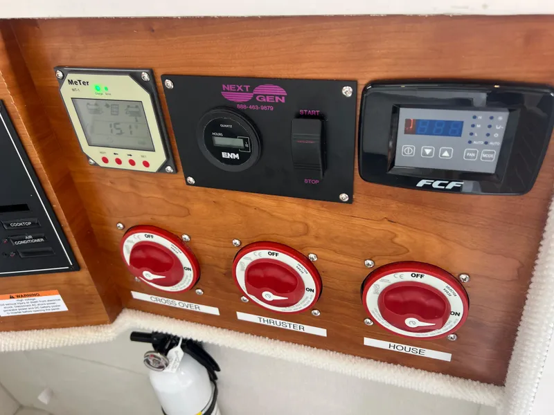 Slide: The Image of Control panel of 2021 Cutwater C28 boat with switches and meters. - 38