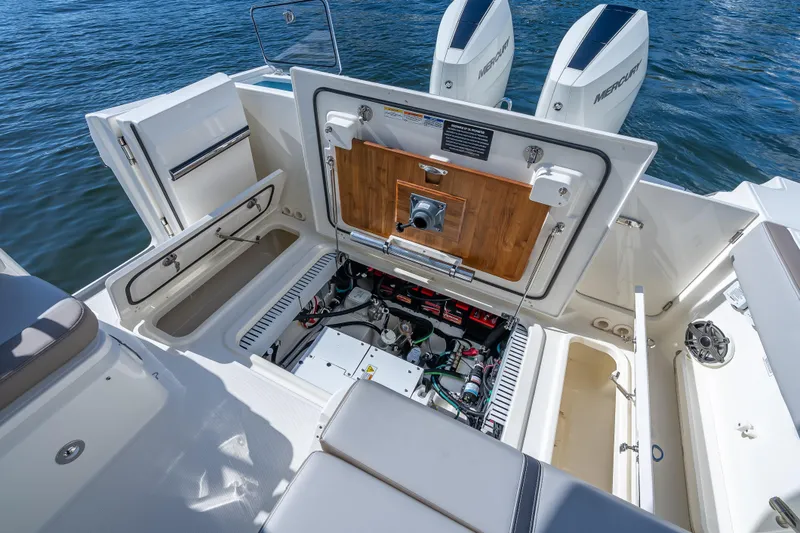 Slide: The Image of 2025 Boston Whaler 330 Vantage boat engine compartment with open hatch, revealing mechanical components. - 20