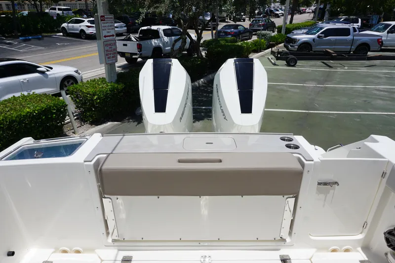 Slide: The Image of 2025 Boston Whaler 330 Vantage boat with dual Mercury engines in a parking lot. - 29