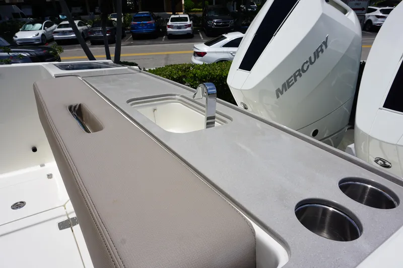 Slide: The Image of 2025 Boston Whaler 330 Vantage boat interior with sink and Mercury engines. - 31