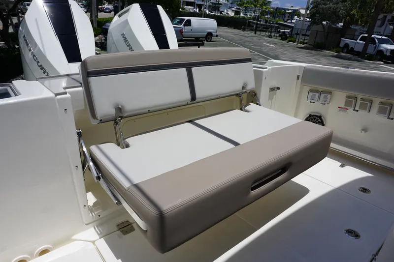 Slide: The Image of 2025 Boston Whaler 330 Vantage boat seating area with dual Mercury engines. - 33