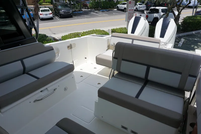Slide: The Image of 2025 Boston Whaler 330 Vantage boat interior with seating and dual engines. - 34
